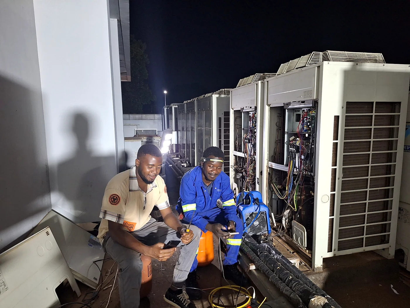 Topworks technicians carrying out Daikin VRV repairs and diagnostic testing on commercial rooftop units