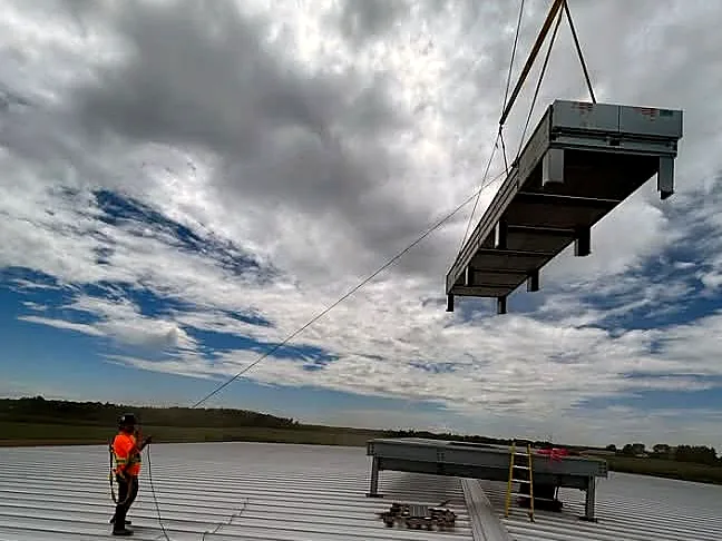 Lifting HVAC equipment onto a commercial rooftop
